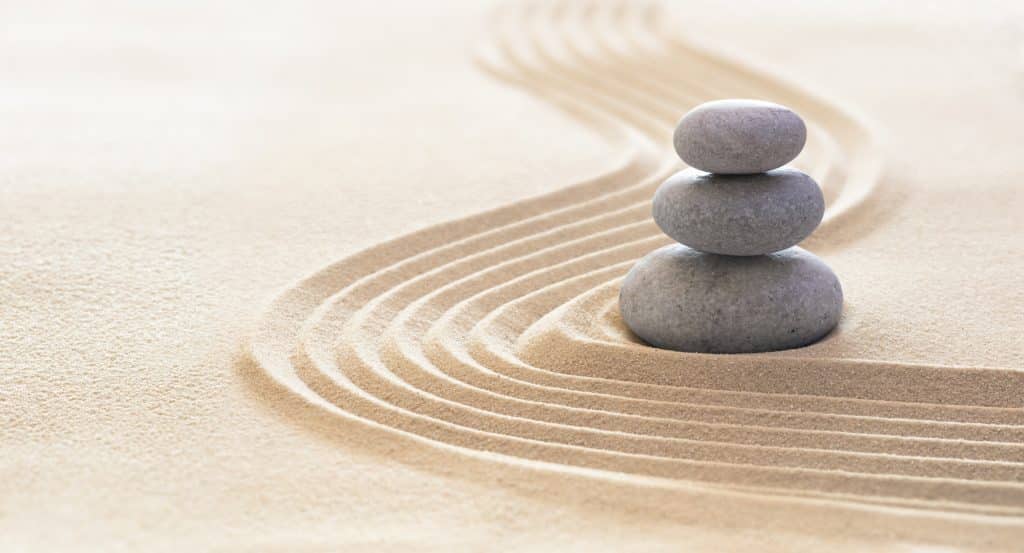 Zen garden with stack of stones in raked sand